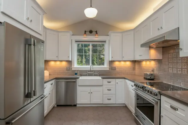 Kitchen cabinets refinished in a sprayed white