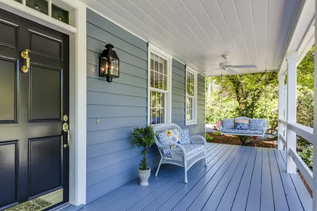 A porch and front door repainted in deep blue